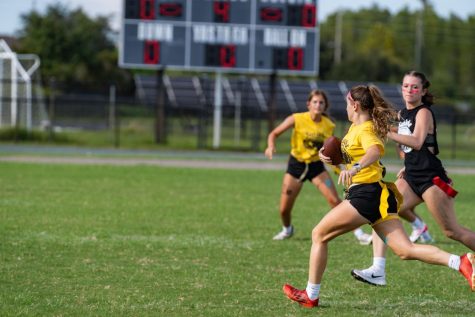 Freshman Kylie Hudgins participates in Sunlake High schools Powder Puff. With typical player roles reversed, she plays football while cheered on by male students in the sidelines.