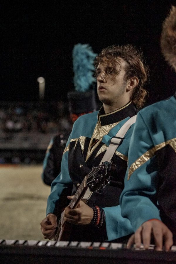 Marshall Garoutte, a senior in Sunlakes Soaring Sound, plays electric guitar along with the other percussion and guitar players. One thing he likes about the show this year is how it has a lot of guitar parts and all of the little features for each section are very well written.