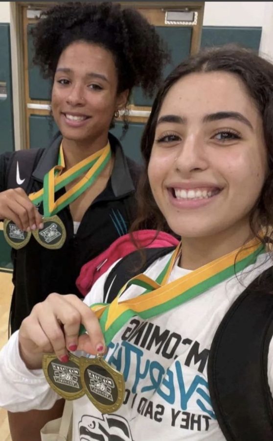Elena Kulubya (left) and Nicole Bouserhal (right) celebrating their victory at the weightlifting event. 