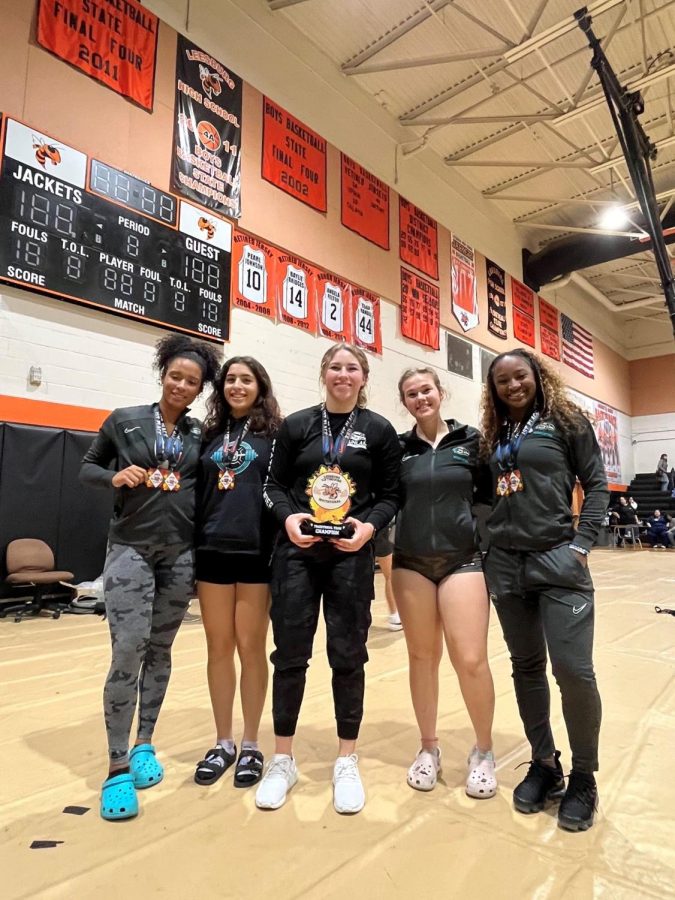 Elena Kulubya (far left), Nicole Bouserhal (second left), and other members of the weightlifting team after their win.