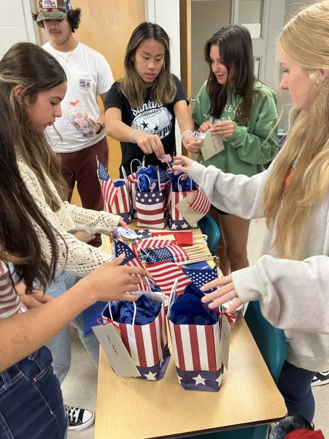 Students+in+the+Freedom+365+club+prepare+bags+that+will+be+handed+out+to+teachers+who+served+in+the+military+as+a+thank+you.