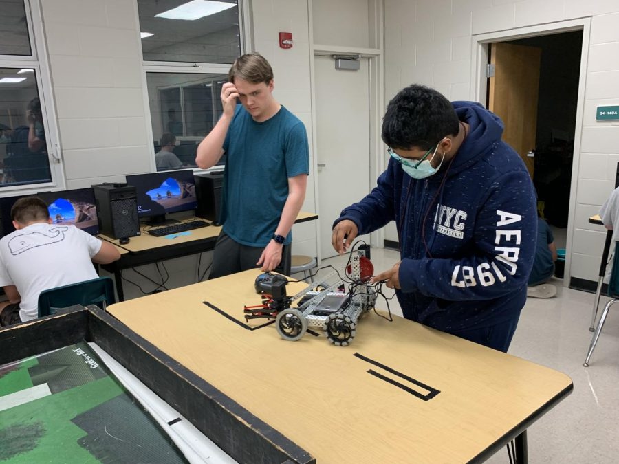 Ty+Cockerham+and+Vadaant+Sarker+%28left+to+right%29+try+to+repair+a+wheel+malfunction+for+their+robot.+Since+they+are+both+seniors+this+year%2C+these+two+will+need+to+teach+the+underclassmen+about+the+club+and+how+it+operates+and+aims+to+compete+this+year.