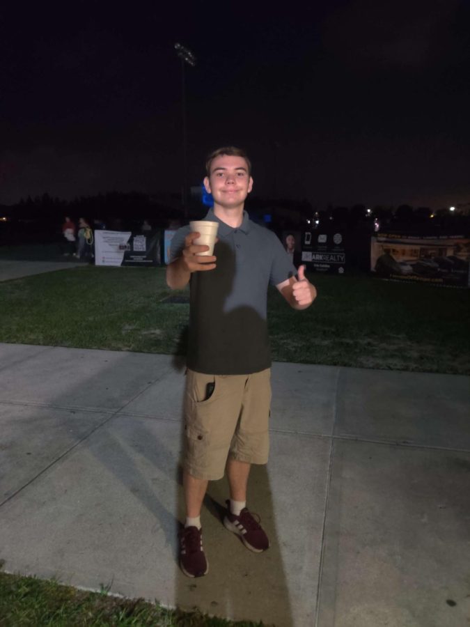 Senior Nick Hiltz is showing off his hot chocolate at the movie night