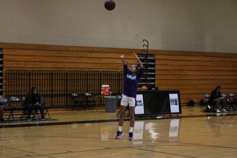 A member of the Girls basketball team on the court during pregame practice.
