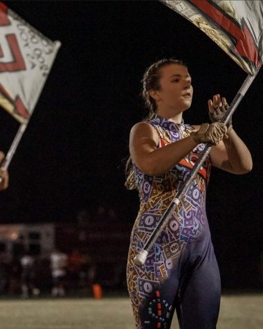 Keely Fink spinning her flag during a color guard show.