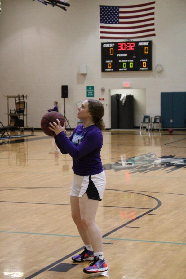 A member of the Girls basketball team on the court during pregame practice.