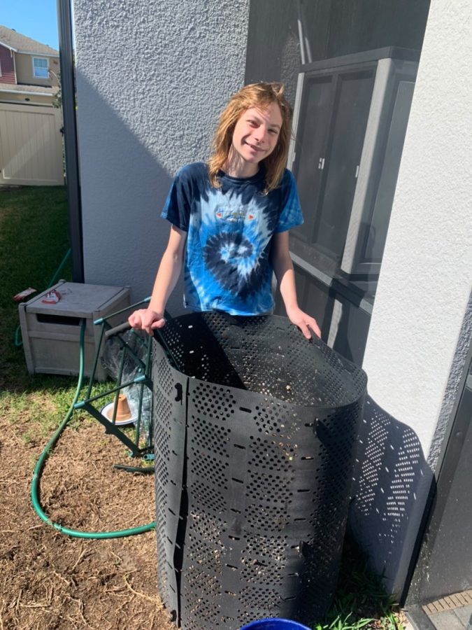 Sophomore, Atticus Ama, stands by his pride and joy; his compost bin.