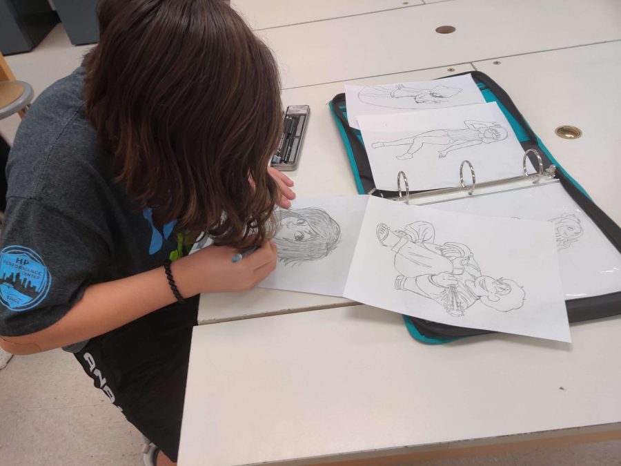 Freshman Nikhyll Machadl drawing another character using his sketching tools.