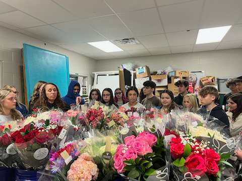 Student council preparing to wrap and ship out flowers for the flower gram. Ava Edwards (on the middle left with glasses on)
