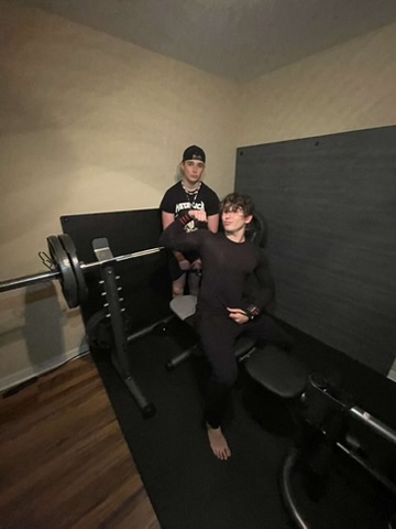 Koen Devenny and Bryant Pollard near a weightlifting bench.