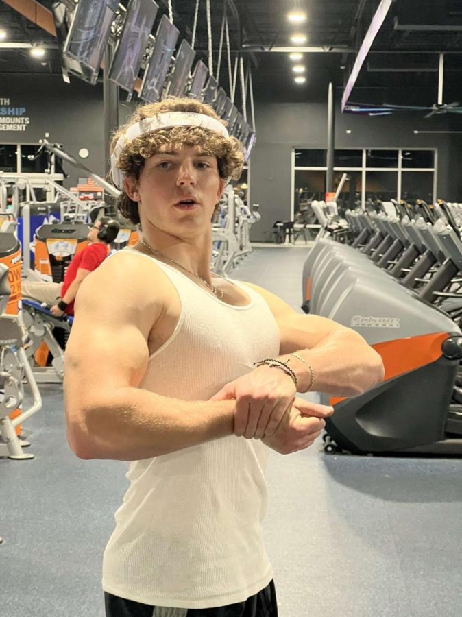 Zachary Merriman (Junior) flexing his arms during a killer arm workout