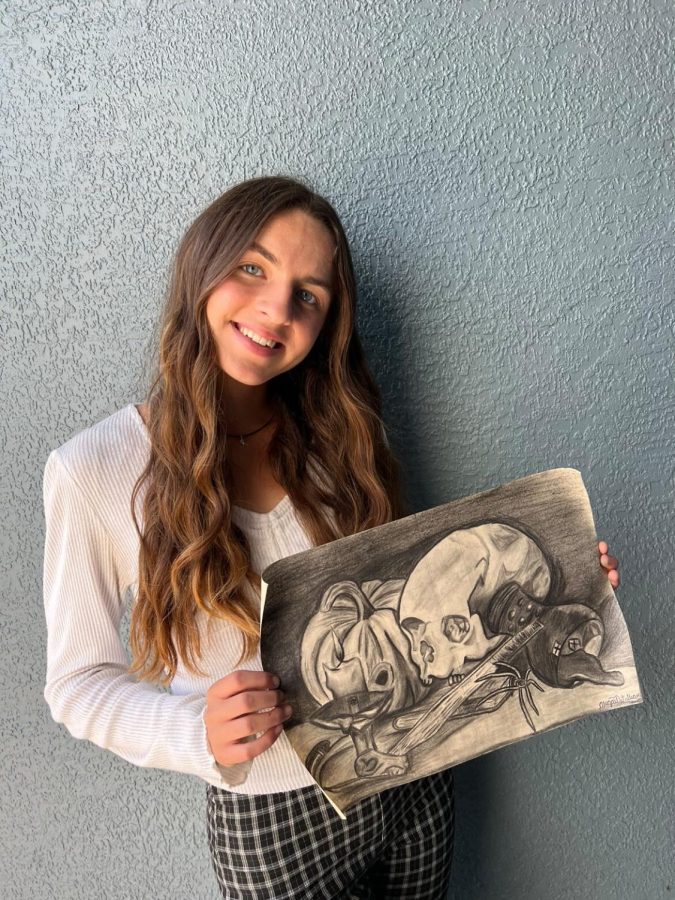 Abigail Williams poses with her artwork.