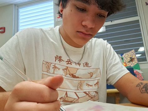 Tebius Harper working hard in his AP 2-D art class.