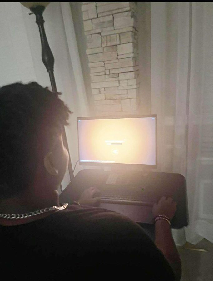 Junior, Quawn Green booting up roblox on his at home computer.
