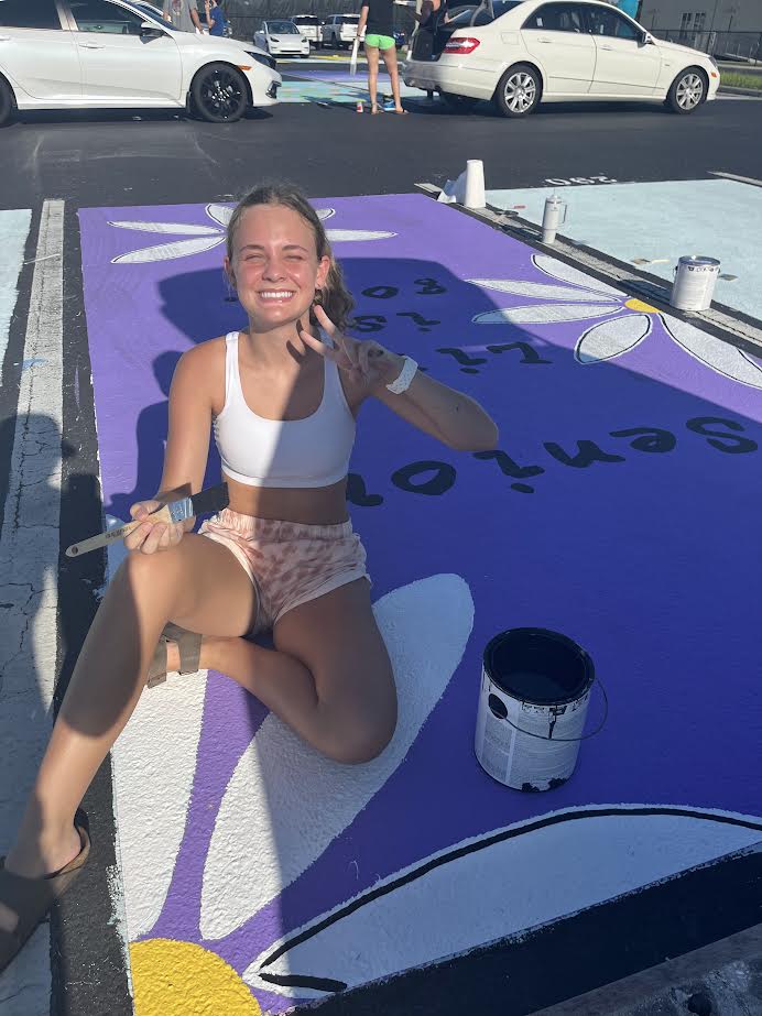 Senior Rylee Vogt painting her parking spot on August 5th, 2023.