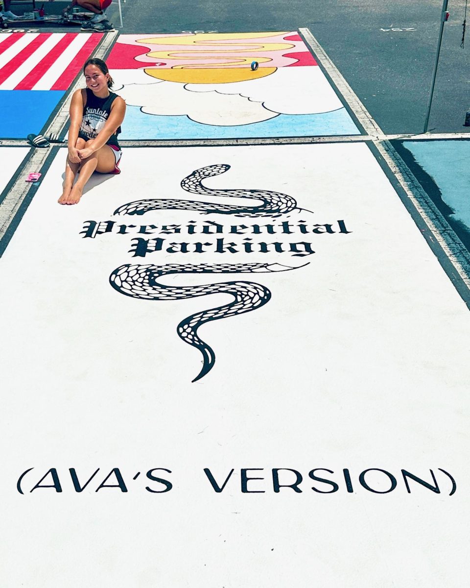 Ava Edwards posing with her newly painted Taylor Swift themed parking spot.