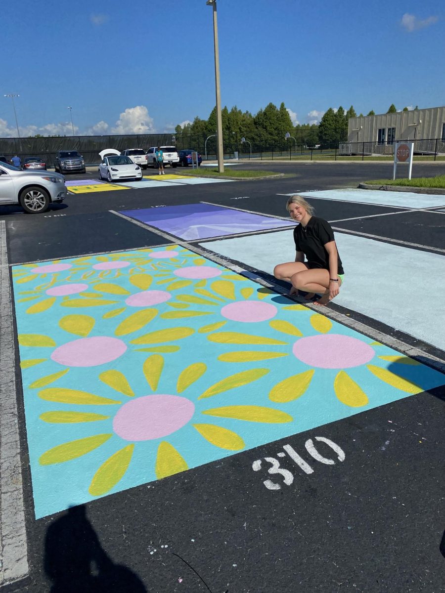 Senior, Jillian Moore painting her parking spot.