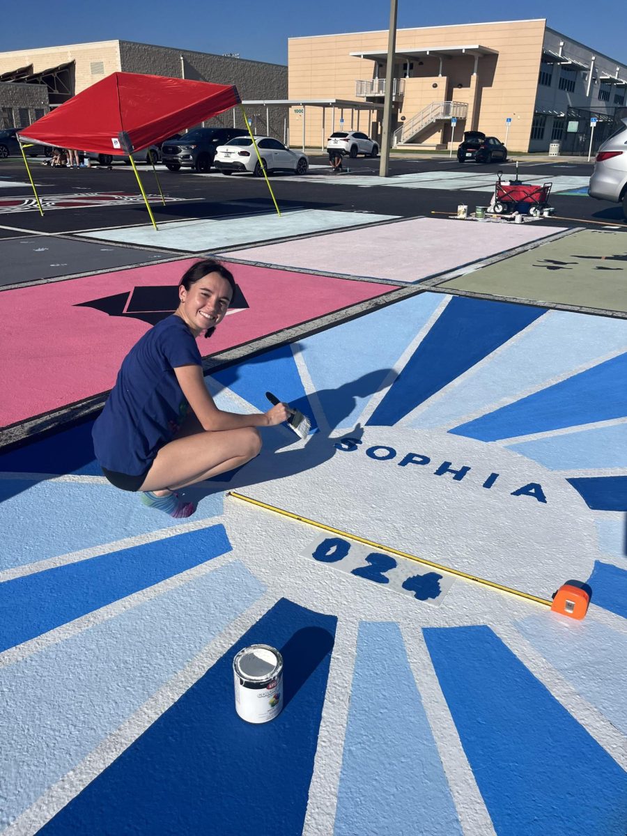 Sophia Cataldo painting her parking spot for her senior year.
