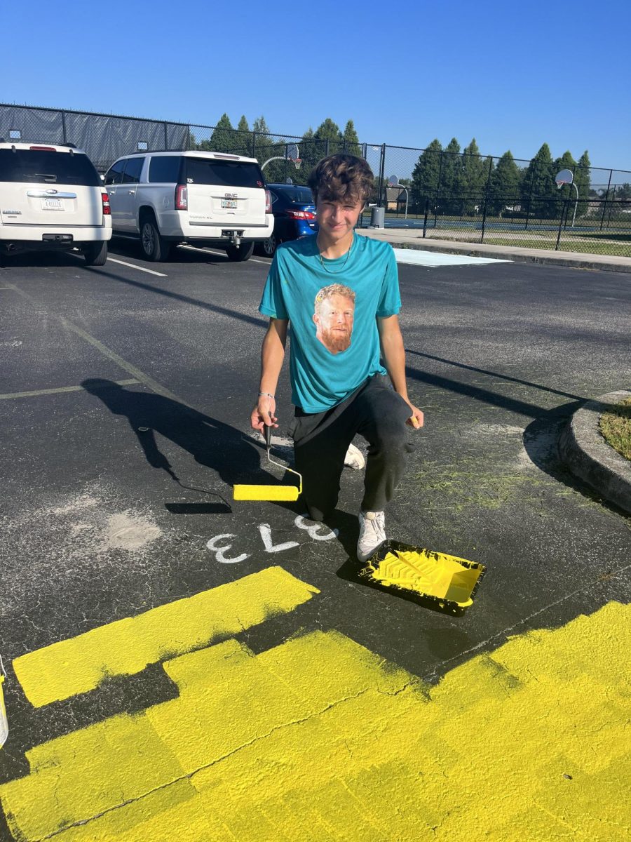 Senior Evan Bagniuk looking forward to his senior year by painting his very own parking spot.