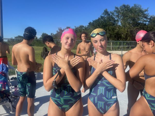 Two members of the Sunlake girls swim team pose at their swim meet.