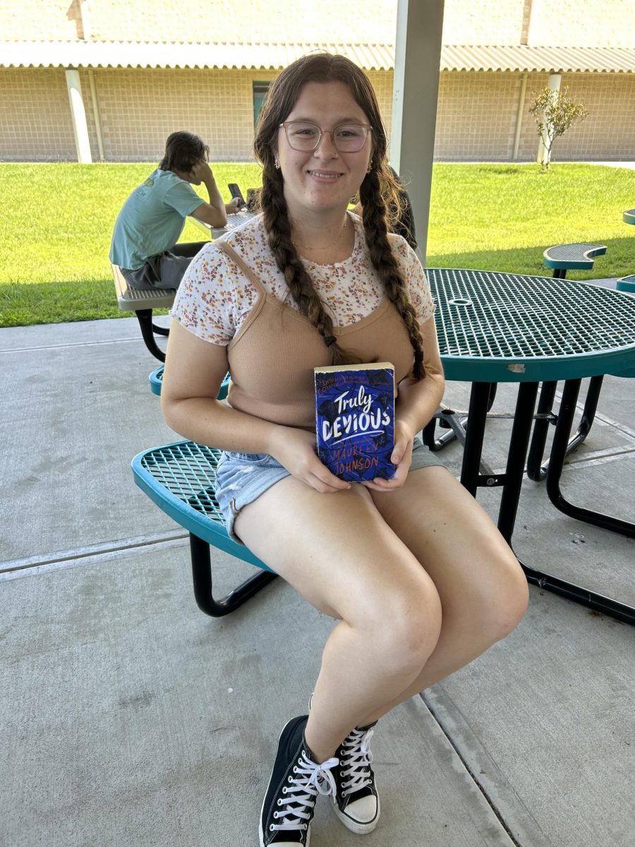 Senior Lauren Brown with the book Truly Devious chosen for Book Club.