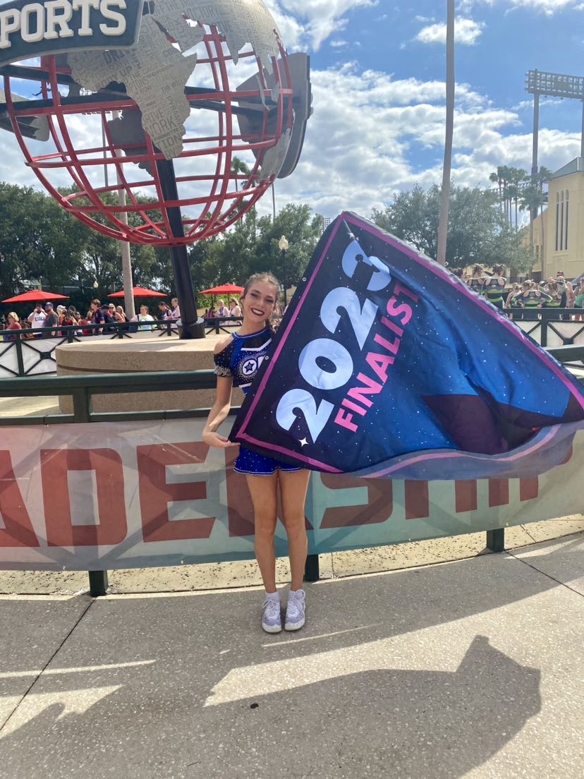 Anastasia at ESPN World Wide Sports center. Anastasia taking a picture with her finalist banner. Anastasia states Im so happy to be here.