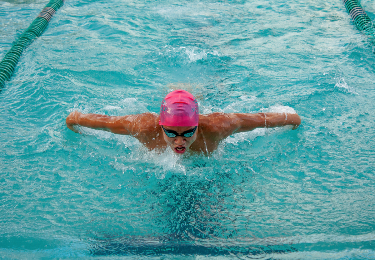 Junior Huy Duong swims a 50-meter butterfly at his first meet of the season. Duongs speed helped the team take the victory at their first meet. The butterfly pictured is Duongs second favorite stroke to swim.