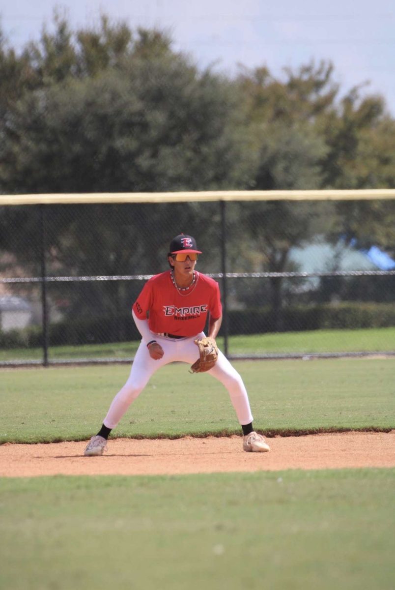 (Freshman) Jake Santana playing short stop for his travel baseball team Empire Baseball. He is prepared for any ground ball that comes to him.