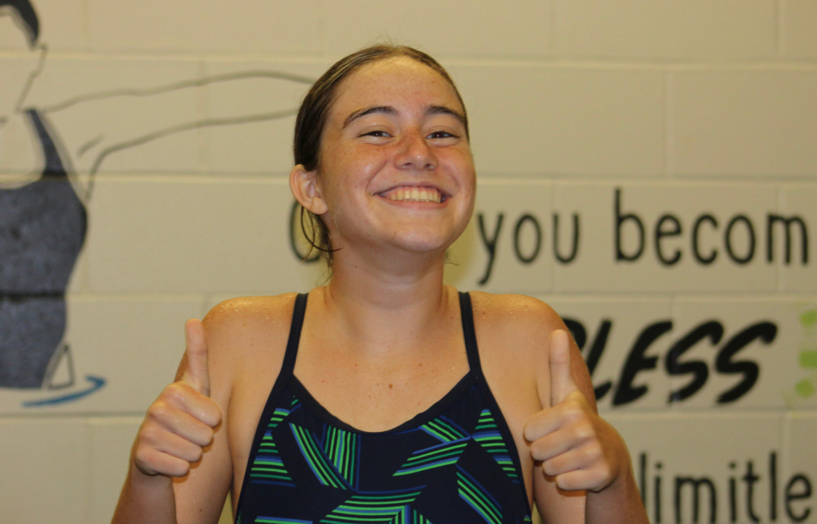 Freshman Mia Fackler gives two thumbs up at her practice before a meet. Fackler experienced her first year of swimming on a high school team this year and found it ...really fun and challenging. This freshmans smile and thumbs up shows how she always has a positive attitude, which will take her far. 