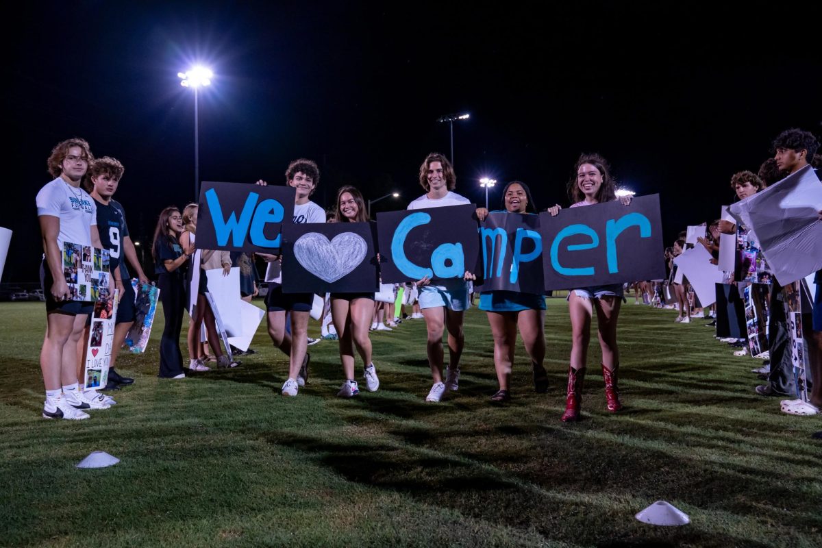 Seniors Armando Cabrera, Ava Edwards, Daniel Storchevyi, Olivia Sutton, and Zoe Bastable holding up thank you signs for Ms. Camper during their poster walk at skit night. Students gave an extra shoutout to the class of 2024 sponsor. Her daughter, Zoe Bastable, said Camper ...had no idea this was happening and appreciated it so much. 