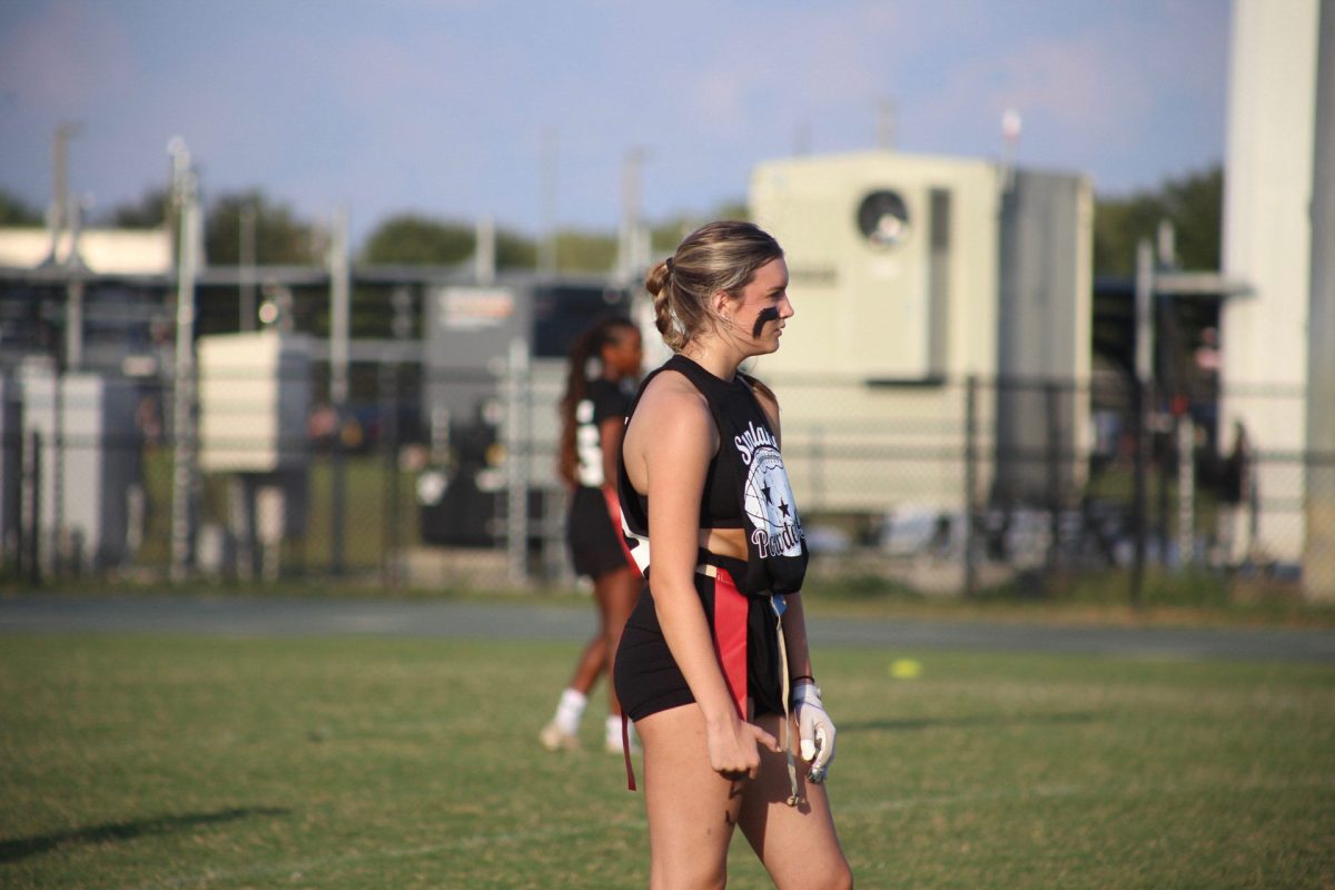 Junior Kailey Morgan during one of her powderpuff football games. She looks over at the offense getting ready to make a play. 