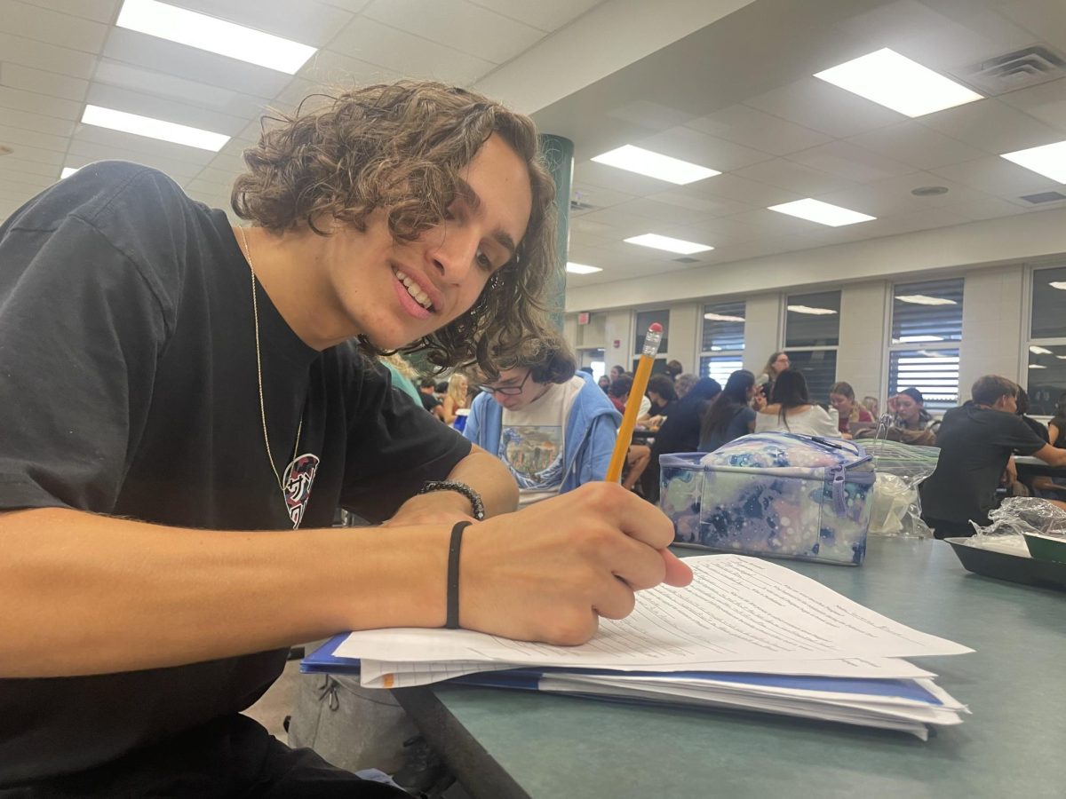 Lorenzo Blanco working on assignments for class while in the lunchroom.