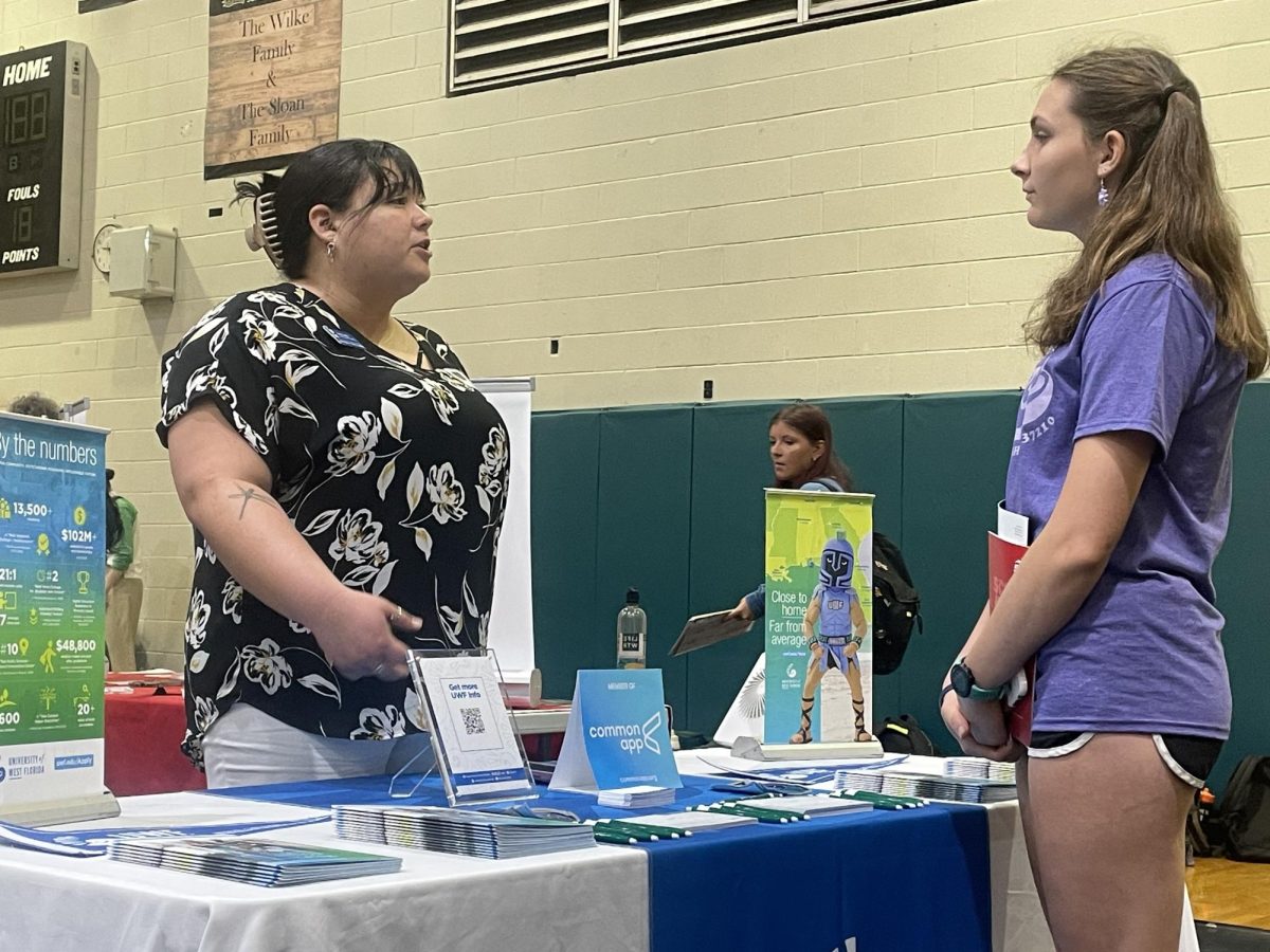Maggie Chauncy talking to one of the admissions officers at the college fair.