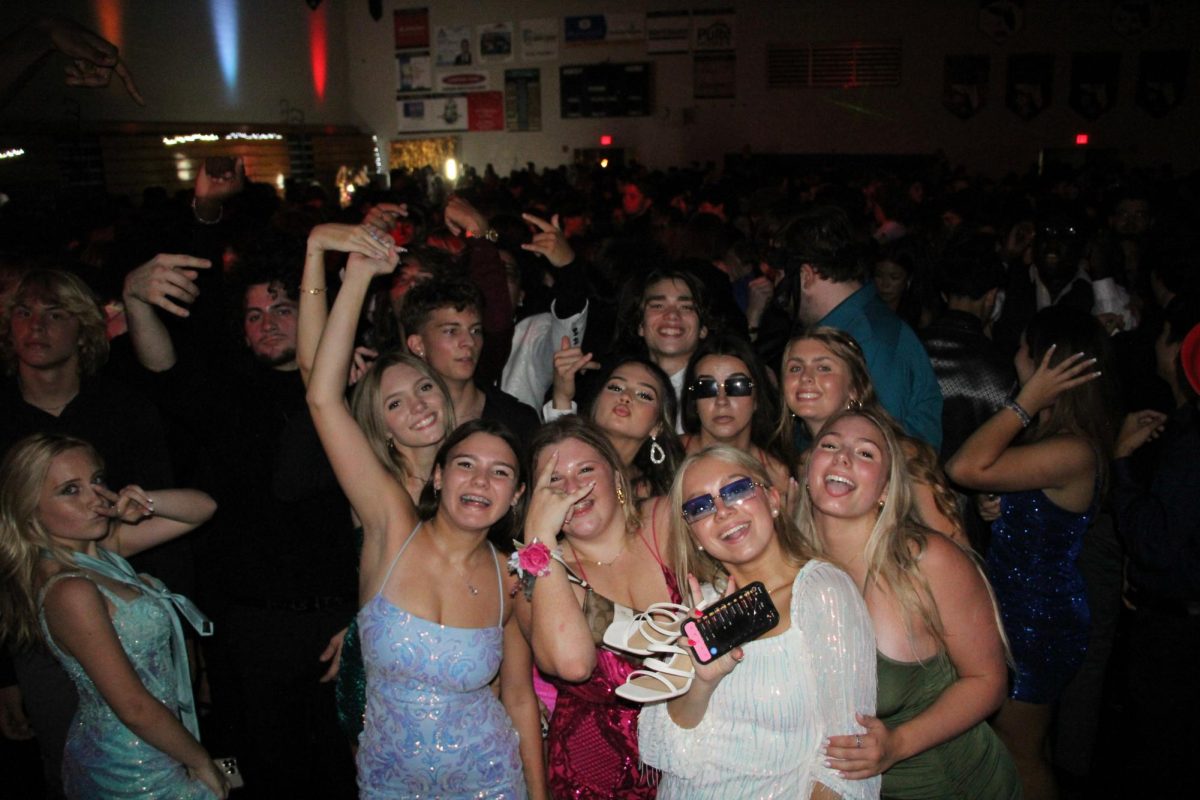 Kalise is the one on the left of the girl with the black sunglasses. She and her friends are posing for a picture during the homecoming dance. Kalise states I had so much fun.