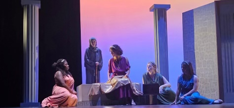 Madison Troiani can be seen on the far right on the ground. Madison and her cast-mates are performing in the play Medea. Madison said, It was really fun and I enjoyed acting.