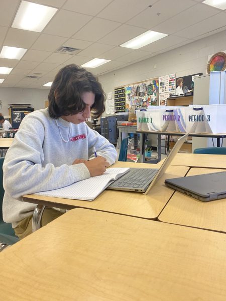 Senior Santiago Rodriguez working on an assignment for Humanities. Santiago stated, I love this class, which makes the work more enjoyable to complete.