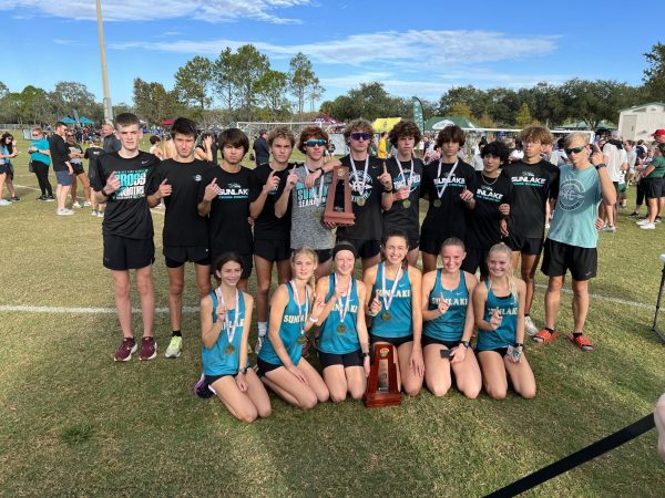 This is a photo of the boys and girls cross country teams with their district trophies. They successfully secured another district win. Jadon was ....so proud of my team. Us boys work really hard and were all really good friends, so its exciting to accomplish great things together.