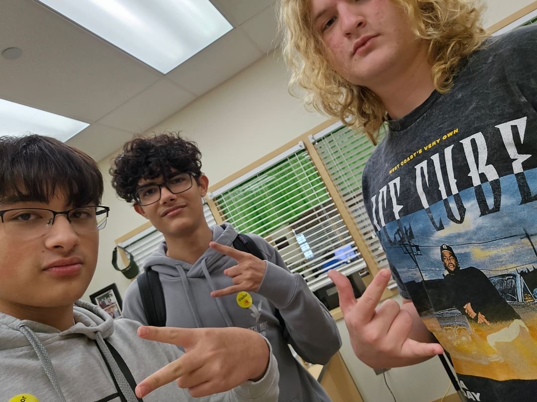 Evan Chase is the person on the far right with blonde curly hair. This is him taking a photo with two friends. This was taken when he was volunteering at oak stead.