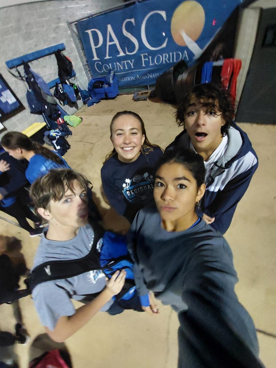 Junior Mia Martin (gray hoodie) and her friends taking a selfie after a cold practice. Practice at night can be really cold, especially during December. Mia said, "Practice is fun, but these past few months, the water is freezing." 