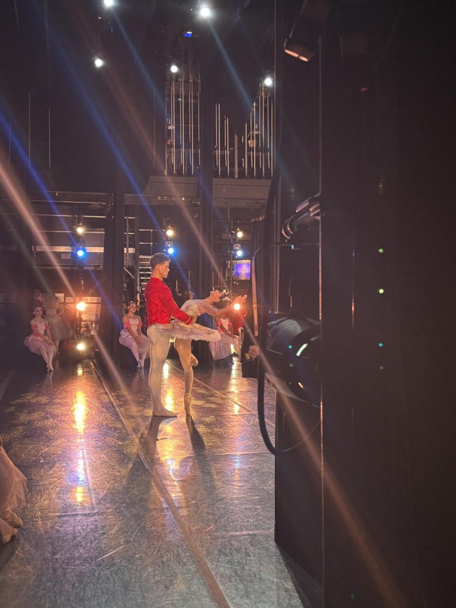 Sophomore Melodi Kazazi watching other people practice on the stage. This was before Melodi had to perform. She said, "...they are pretty good at what they do and for what we have seen, this is gonna be a good and fun show."