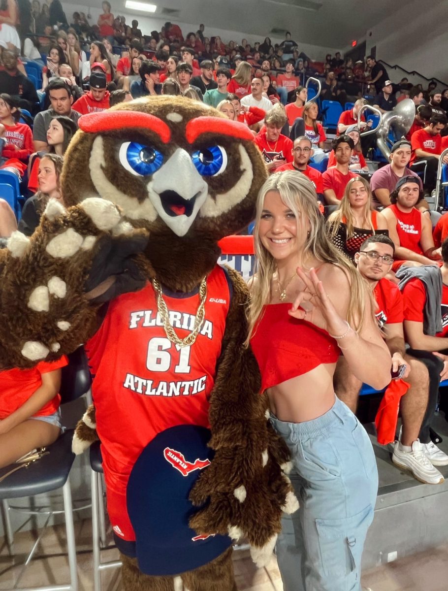 Pictured is senior, Jillian Moore standing with Owsley, FAUs mascot, visiting Florida Atlantic University and attending an FAU basketball game!