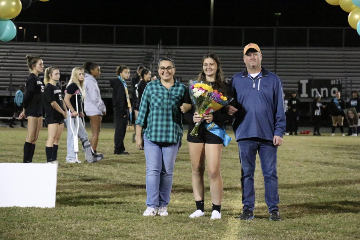 This is Payton walking down the field with her parents during the senior night ceremony. She says, “It was a very sentimental moment seeing all the girls that I’ve been playing with for so long as I was walking down the field.”