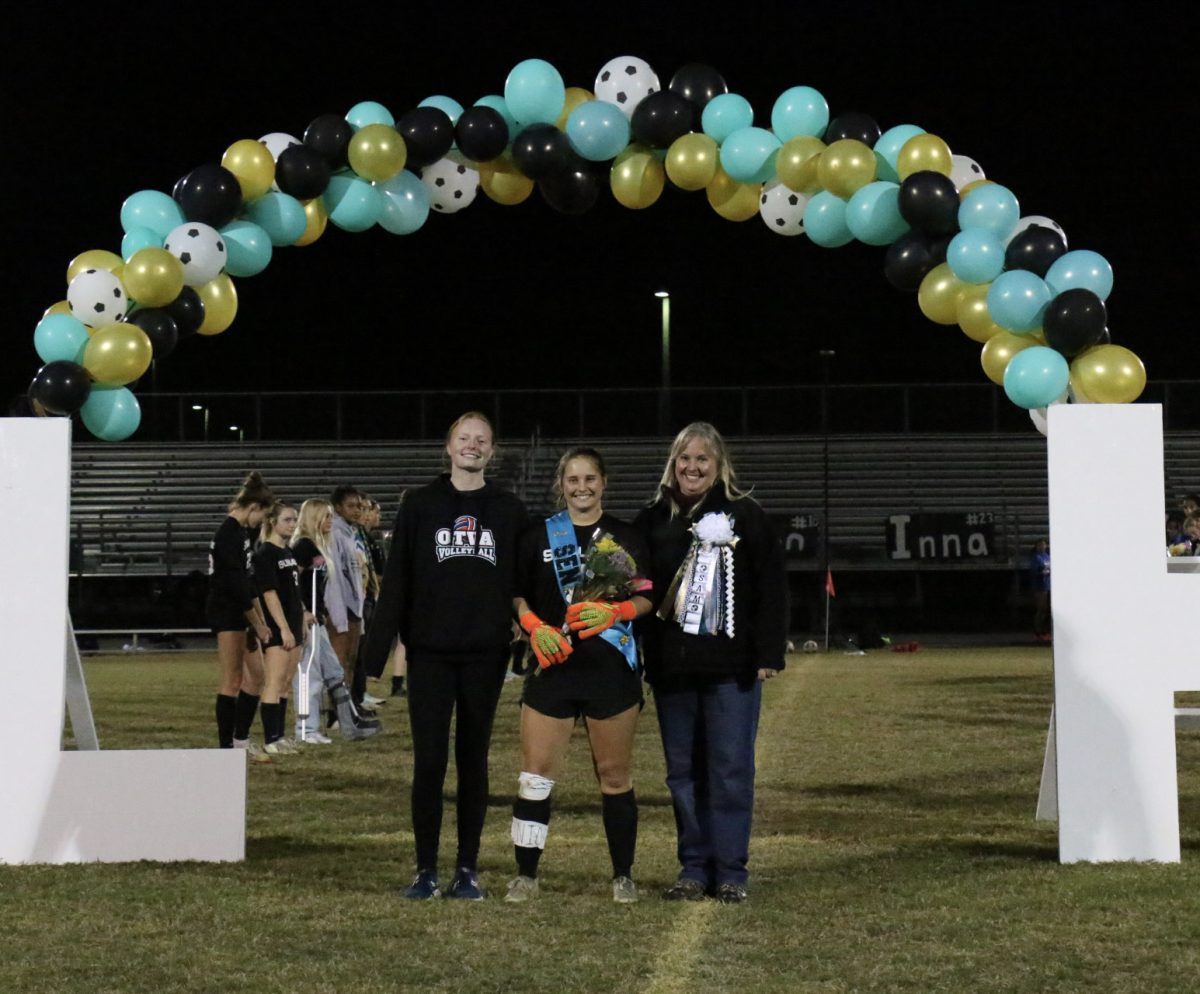 Senior, Samantha Barnes with her little sister and her mom. The feelings ...indescribable... as she walked down the field lined with the friends shes made over the past few years. Sam said, leaving soccer behind is sad but I will always remember the sport I had fallen in love with.