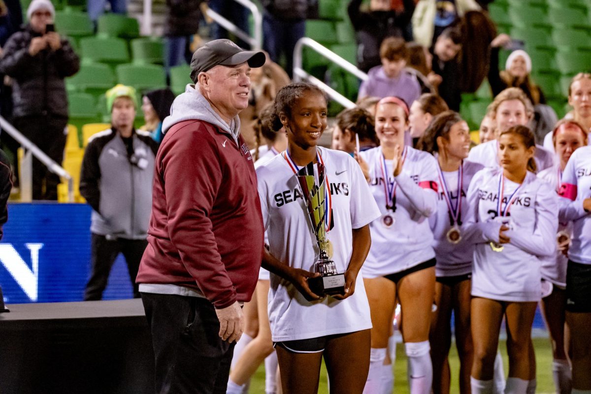 Adia Symmonds holding the girls first place championship trophy after Sunlake's win against Palm Harbor.