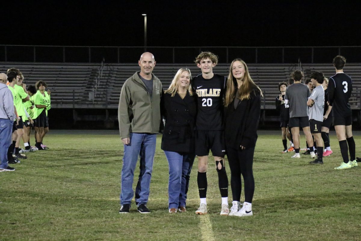 This is Jacob Morrel walking down the field during his senior night ceremony. During the ceremony and during the game, he “… had a lot of fun. It was great having my parents and my girlfriend there to support me.”