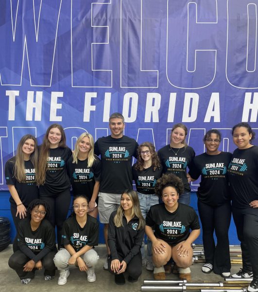 Coach Hodros and the girls that qualified for state after weighing in for the meet. They were all excited to compete and finish a great season of weightlifting off strong. Coach Hodros said, ...youre going to have highs and lows but overall it was a really great season.