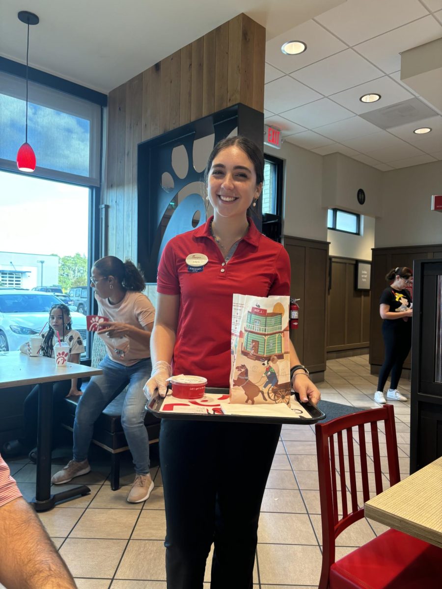 Isabella Santos delivering someones food to them. She said "I really like me job." She enjoys what she does.