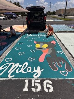 Miley Falby sitting next to her finished parking spot.