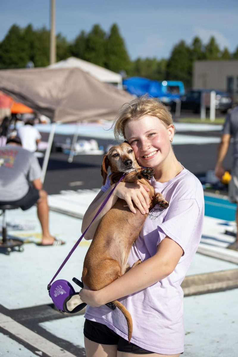 Lily Hatcher (pictured) painted her parking spot with the help of her sister and her lovely wiener dog. She had a really good time and she's so happy that it turned out well, even if it was, "...all thanks to my sister."