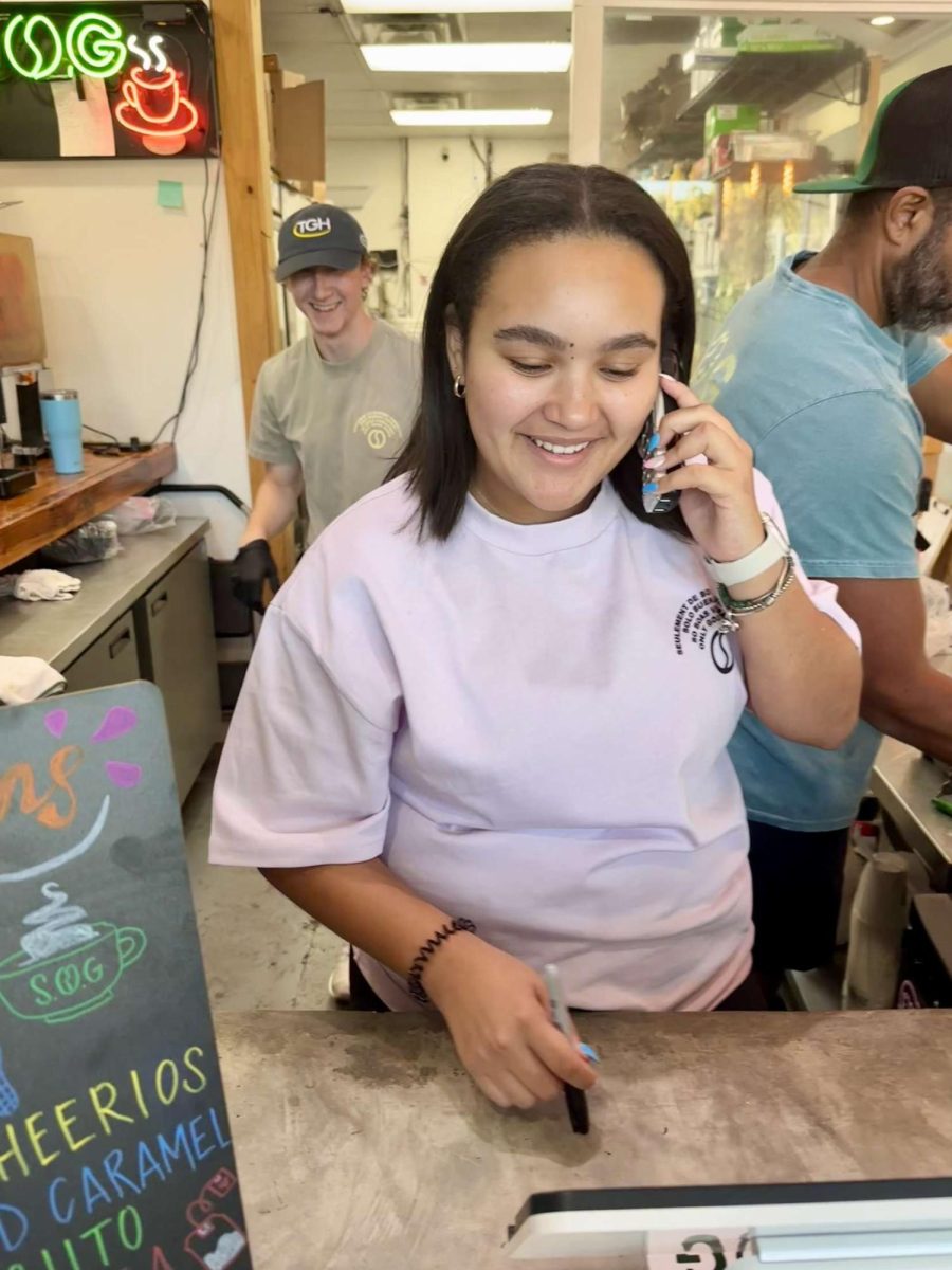 Amelia is working at the front counter. She is making an online order. She says that she, "loves this job!"